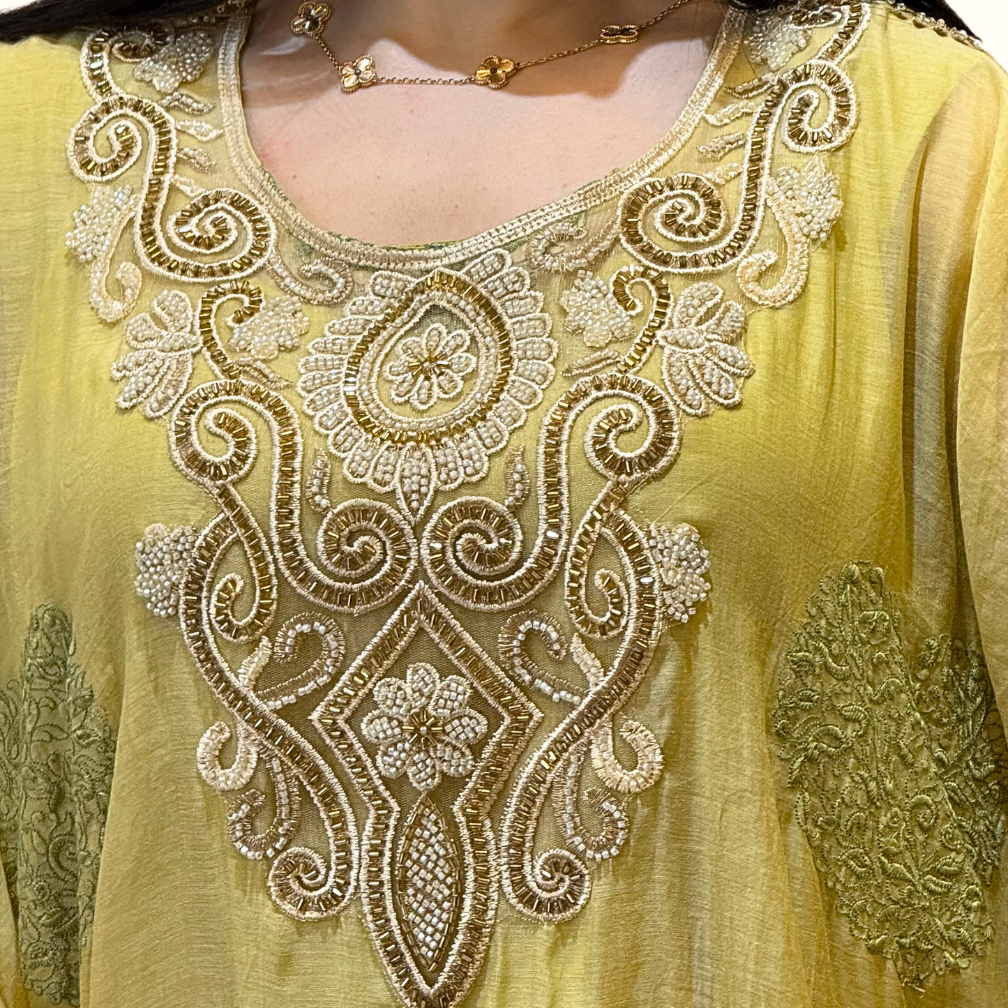 Yellow embroidered garment with intricate patterns