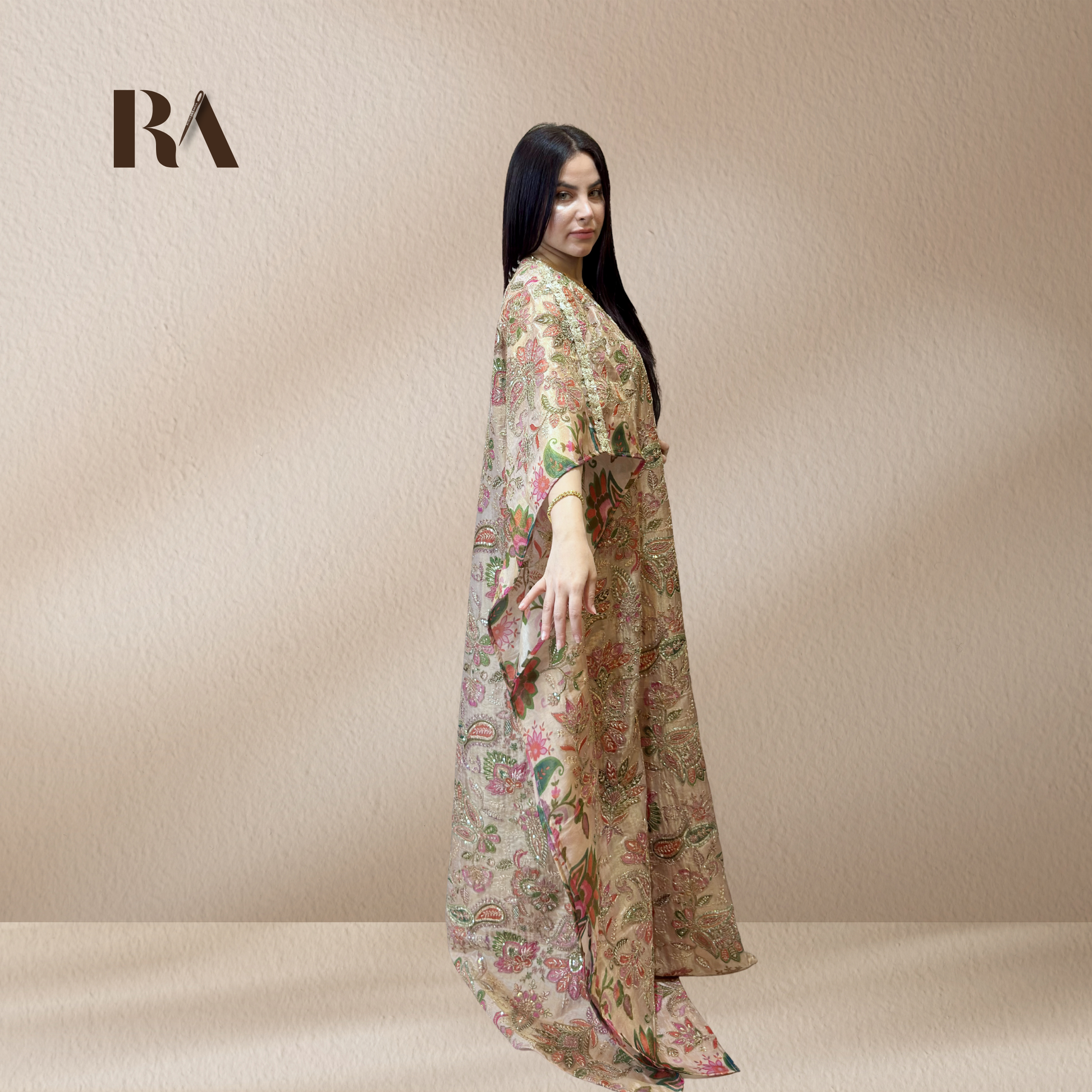 Elegant, fluid drape of butterfly sleeves on Rubeena Ameen beige tissue silk kaftan