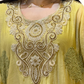 Yellow embroidered garment with intricate patterns
