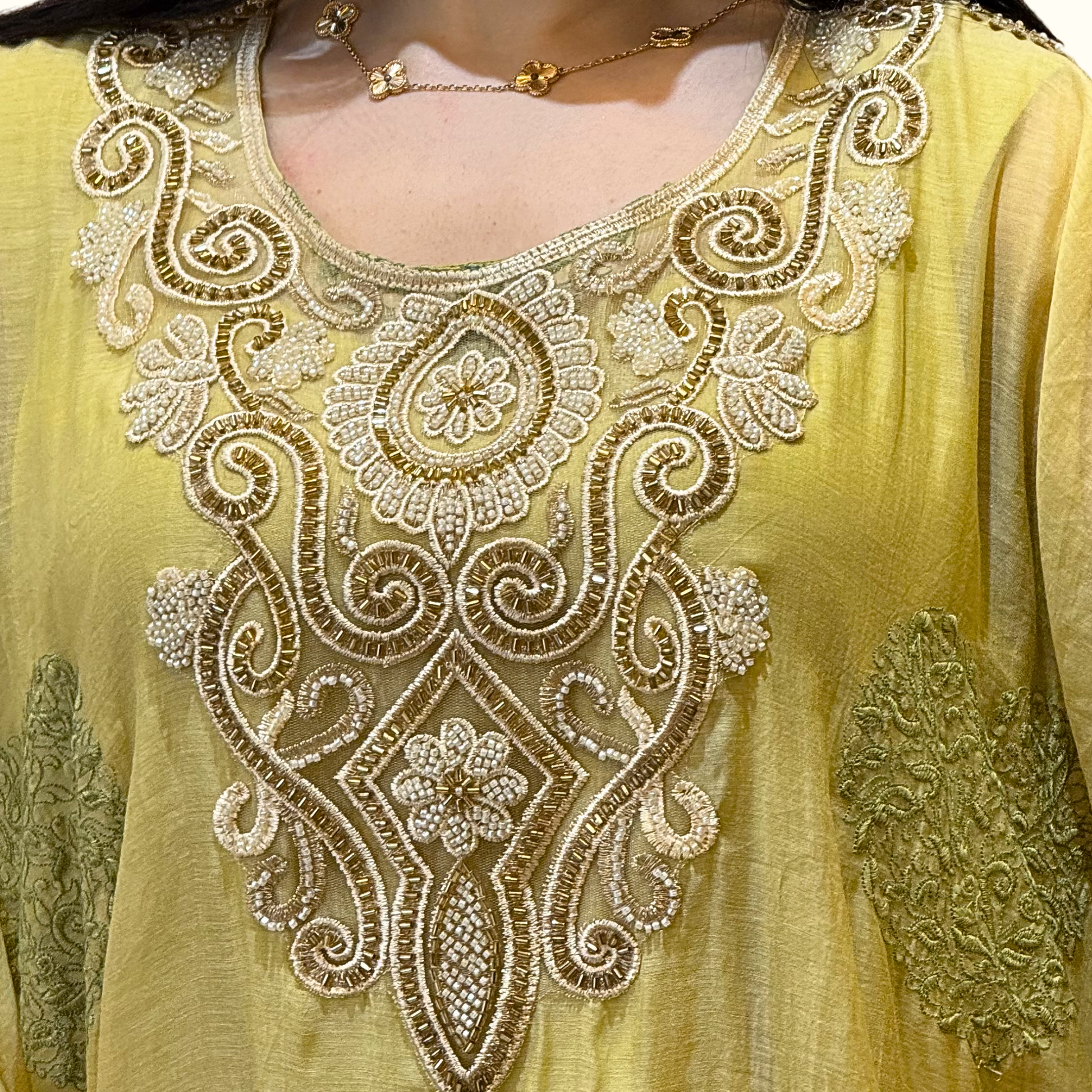 Yellow embroidered garment with intricate patterns