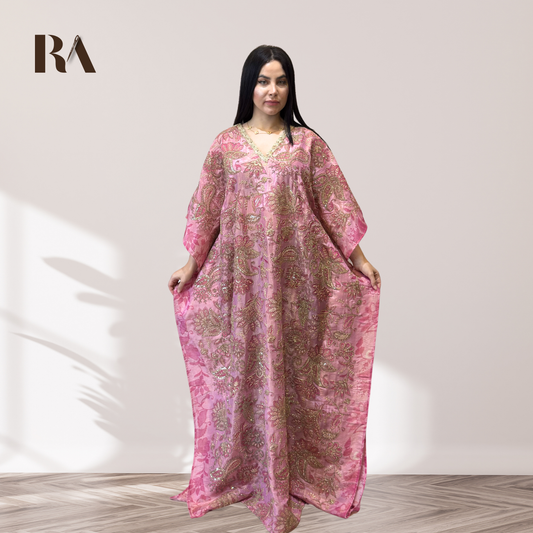 Woman wearing a rose gold zari work kaftan.