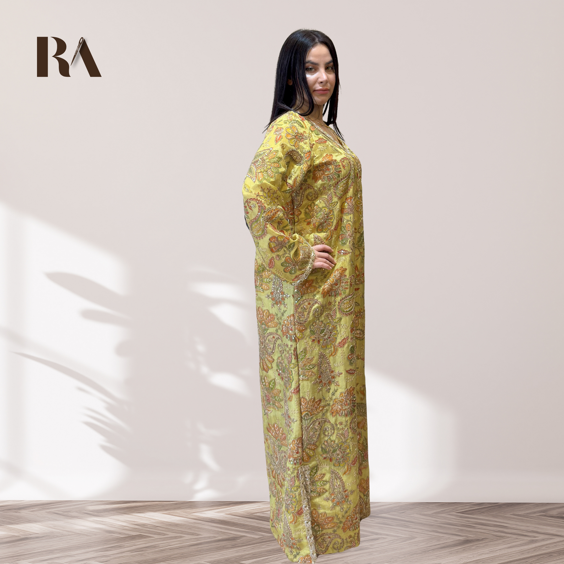 Detailed view of the embroidered long sleeves and fine trim on Rubeena Ameen tissue silk dress