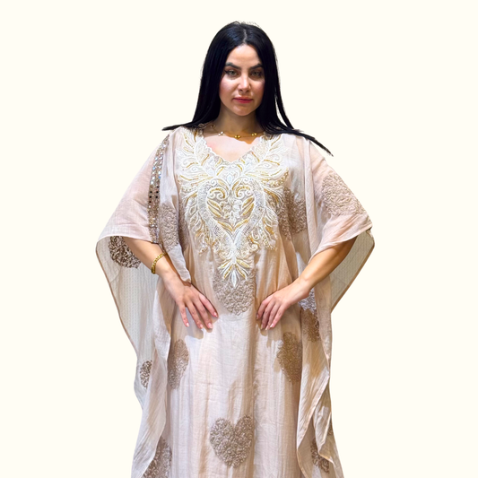 close front view of the clean, minimalist silhouette of Rubeena Ameen ivory white luxury kaftan