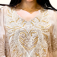 Close-up of the intricate heavy embroidery detailing on the neck and sleeves of Rubeena Ameen ivory dress