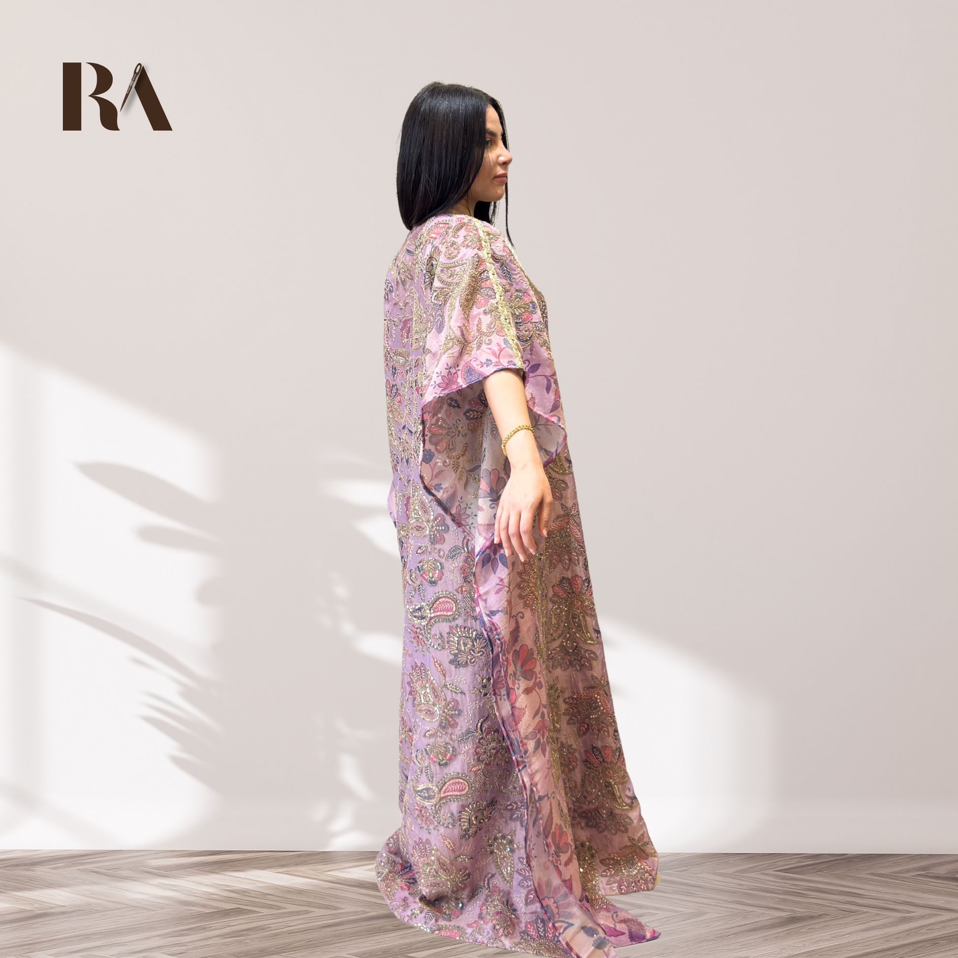 Side view of the elegant wide sleeves on Rubeena Ameen mauve purple kaftan