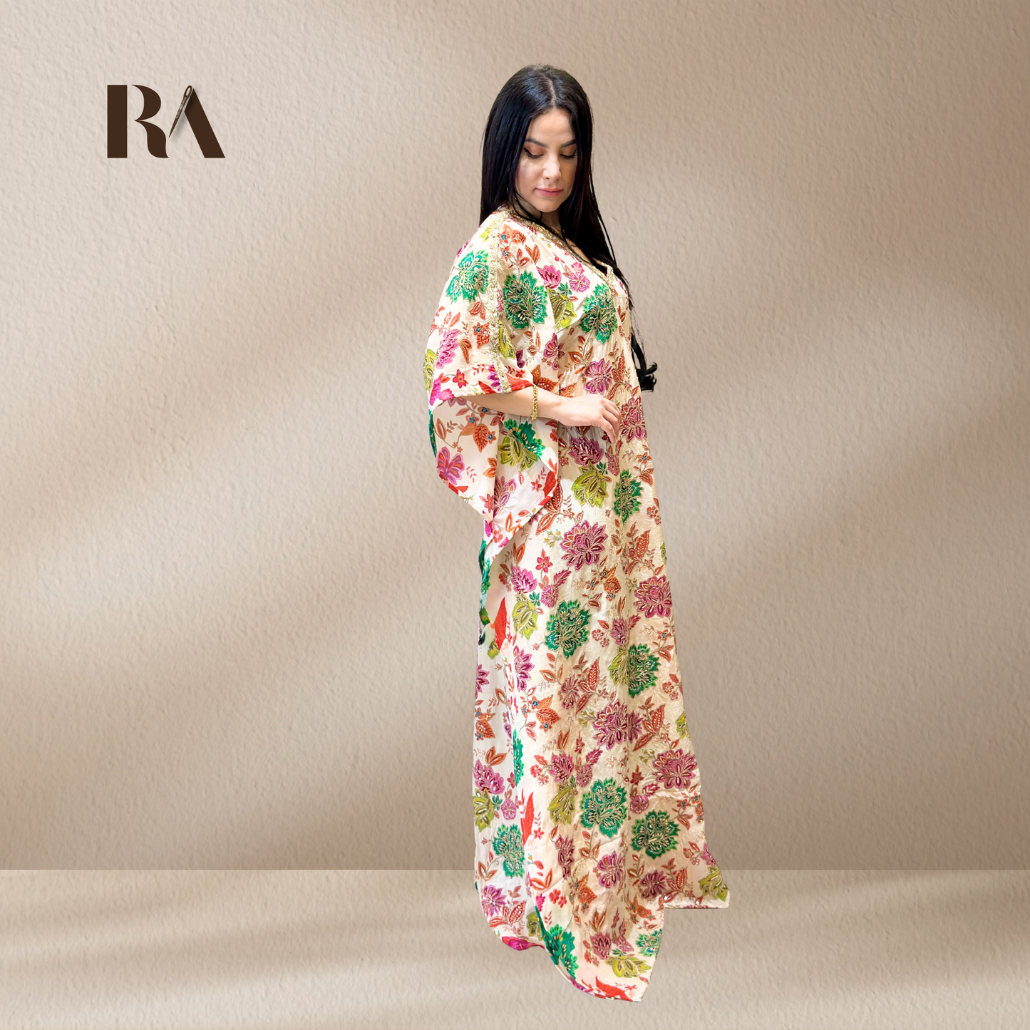 Elegant, fluid drape and wide sleeves of the Rubeena Ameen white crepe kaftan