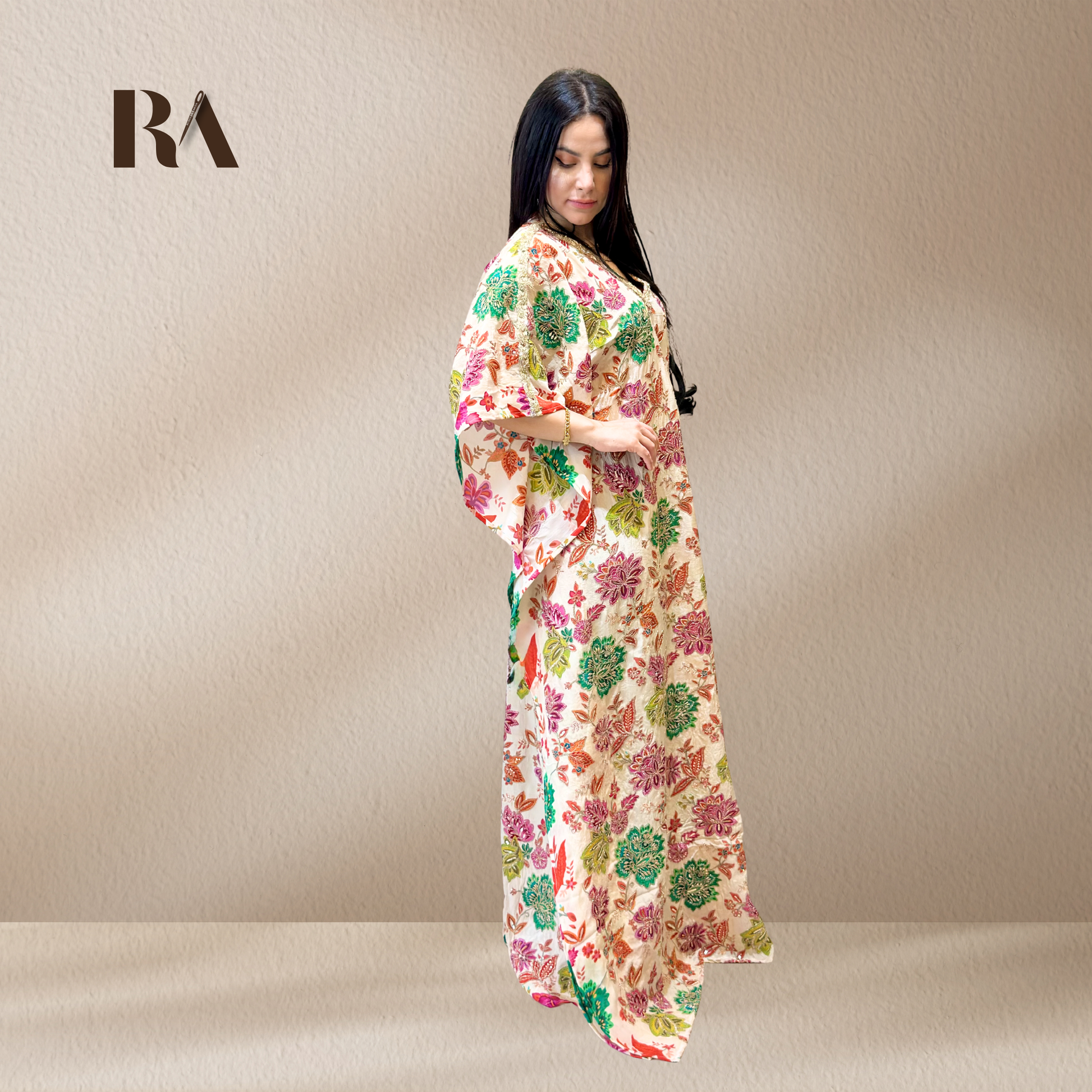 Elegant, fluid drape and wide sleeves of the Rubeena Ameen white crepe kaftan