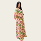 Side view showing the fluid, non-slip drape and wide kaftan sleeves of Rubeena Ameen botanical printed dress