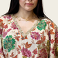 Close-up of the emerald green, magenta pink, and orange floral embroidery on Rubeena Ameen crepe fabric