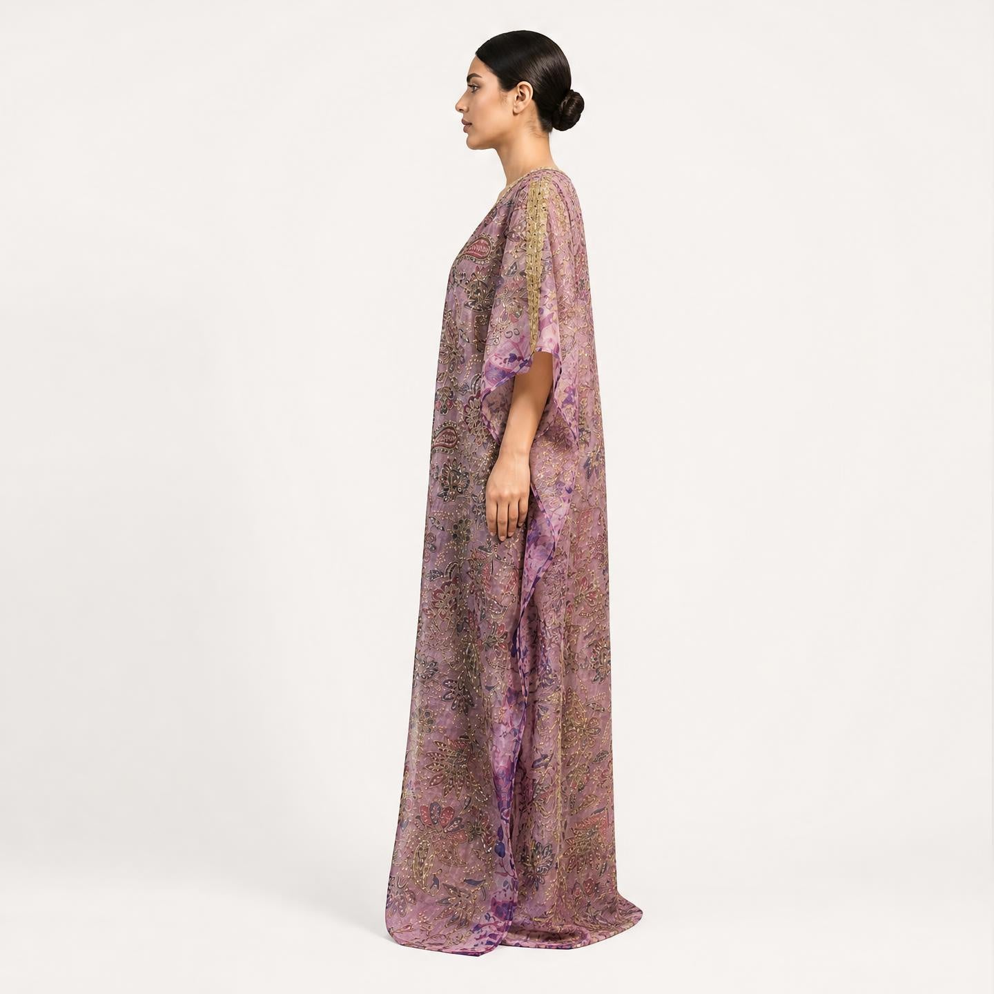 Woman wearing lavender floral tissue silk kaftan maxi dress, side profile view