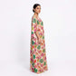 Woman wearing multi flora tissue silk kaftan maxi dress, side profile view