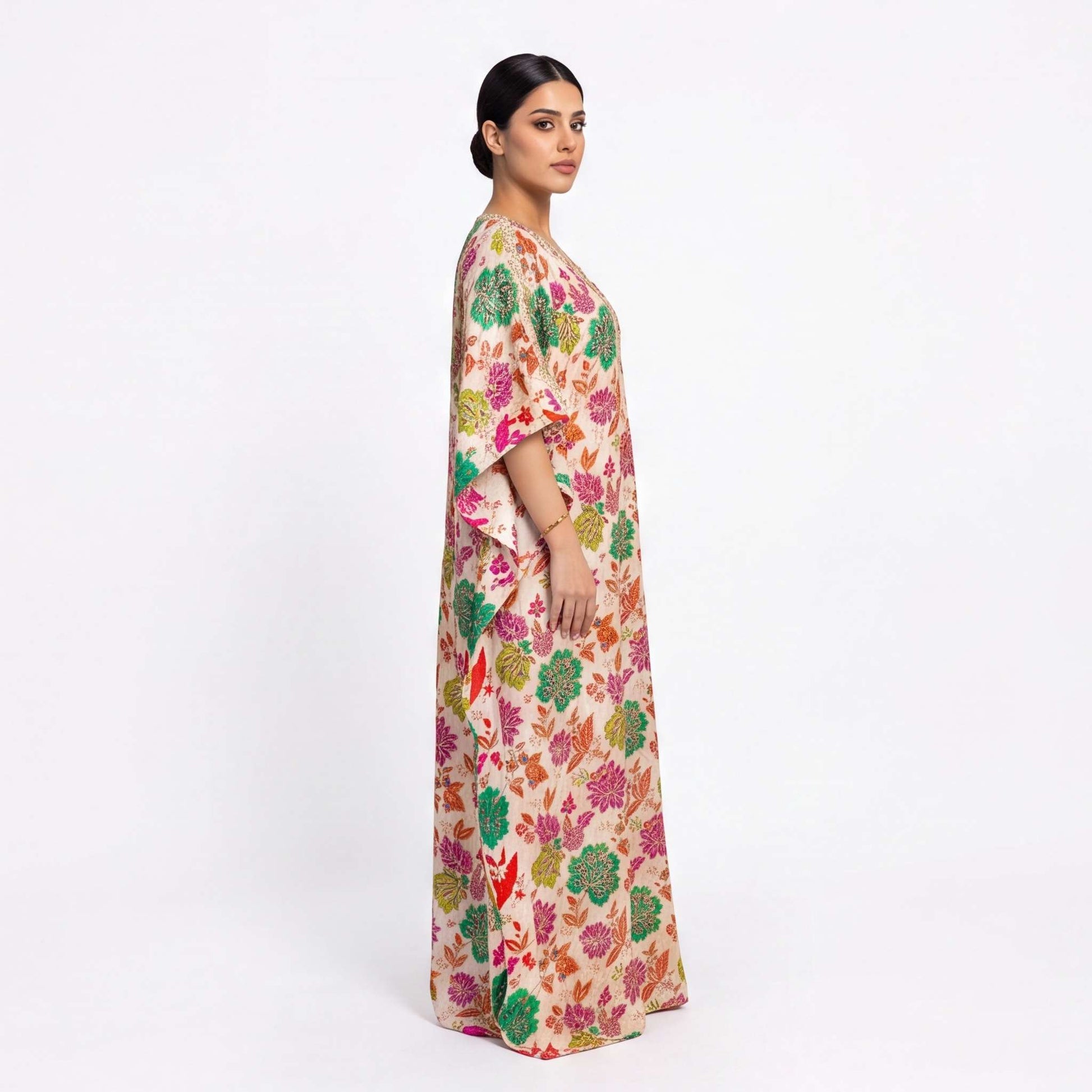 Woman wearing multi flora tissue silk kaftan maxi dress, side profile view