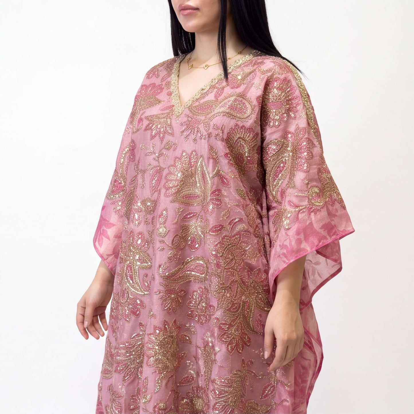 Close-up of rose gold sequin embroidery on pink tissue silk kaftan neckline