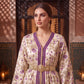 Woman wearing purple embroidered Marrakech kaftan, three-quarter portrait against carved wood door