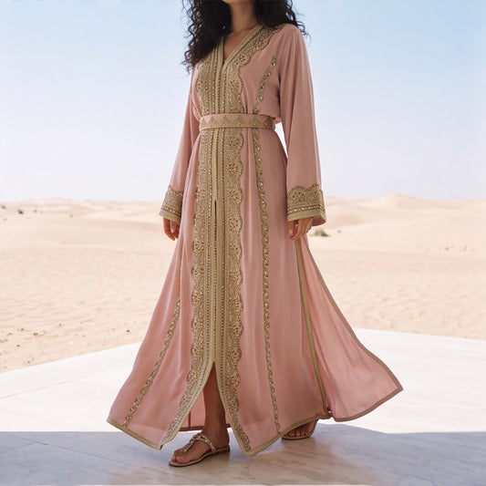 Close-up of the dense gold beaded lace embroidery on the torso of a dusty rose kaftan.