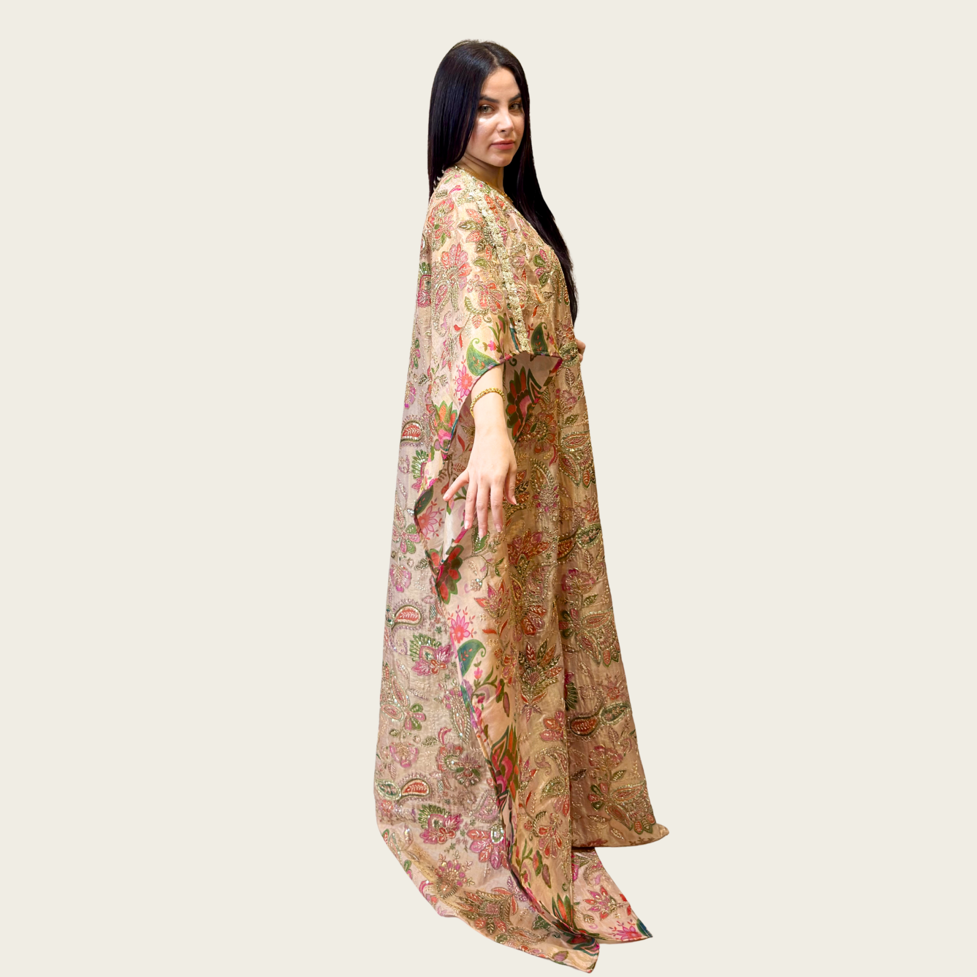 Side profile highlighting the airy, billowing butterfly sleeves of Rubeena Ameen champagne silk dress