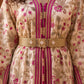 Macro detail of Rose Marrakech Kaftan magenta embroidery and gold beaded belt