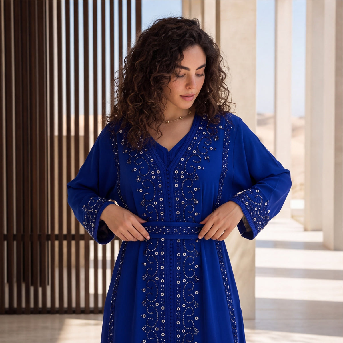 Close-up of the silver and crystal beaded embroidery and belt on a royal blue handmade Moroccan kaftan.