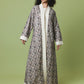 A woman modeling a long, open-front robe with a detailed black and gray damask pattern and a contrasting cream/off-white collar, cuffs, and hem, set against a solid light green studio background.