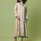 A woman modeling a long-sleeved, wrap-style maxi dress with vertical pastel stripes in pink, yellow, orange, and blue, featuring teal trim, set against a solid sage green studio background.