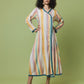 A woman modeling a long-sleeved, wrap-style midi dress with vertical pastel stripes in yellow, orange, pink, and blue, accented with teal lace trim, set against a solid sage green studio background.